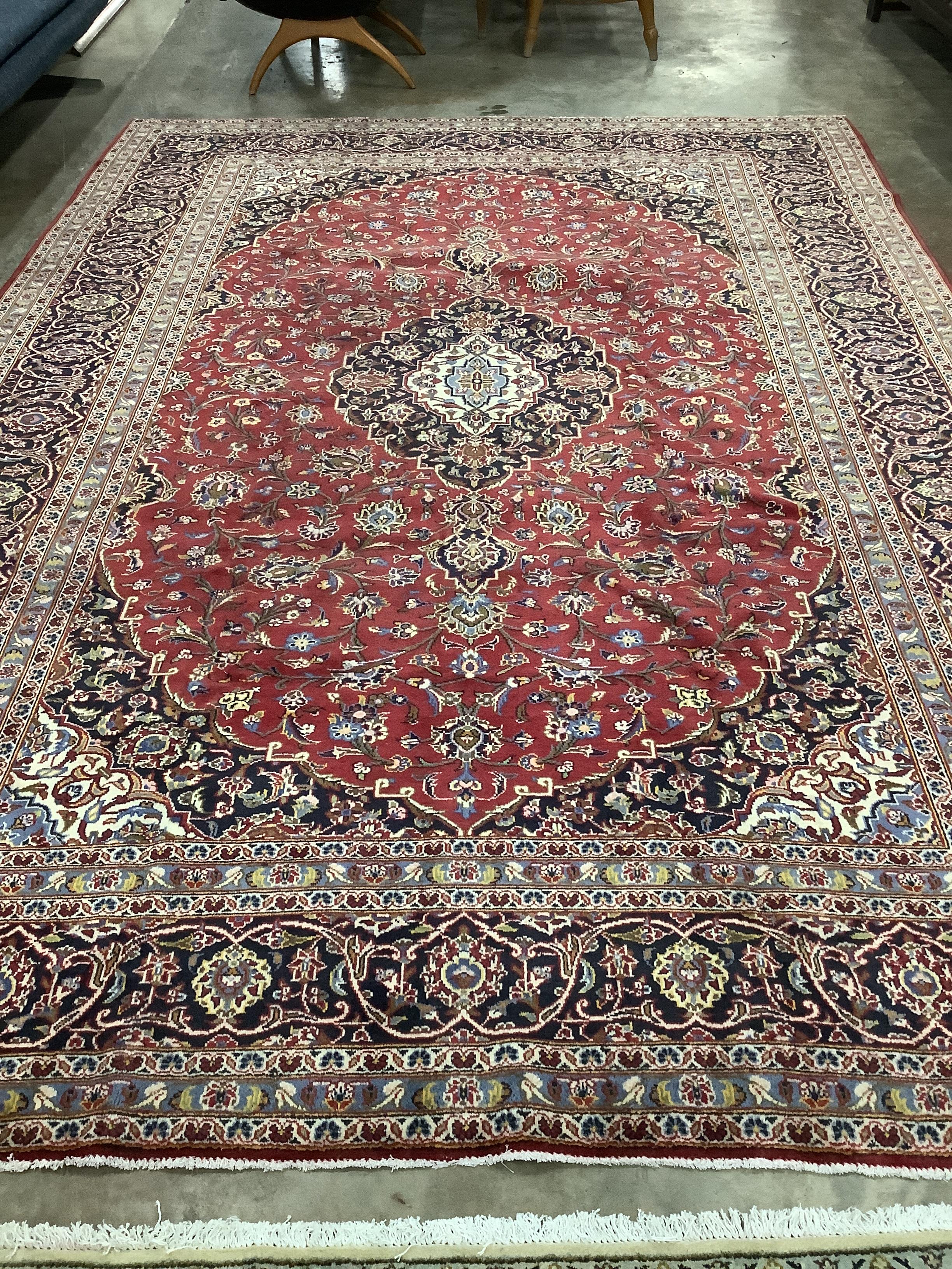 A Kashan red ground carpet, 355 x 240cm